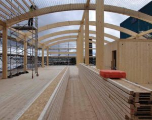 large arched timber roof under construction