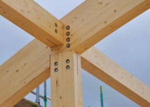 timber pillar with heavy duty timber roof structure coming off it