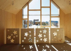 flower cut timber panels inside a timber room looking out a full heigh window