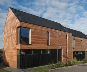 timber house with corrugated roof and black timber cladding on the lower corner