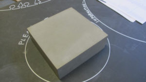 block of stone on a blackboard table top