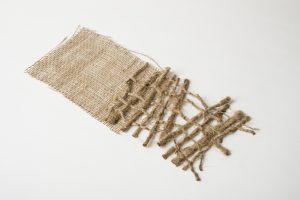 thin sheet of jute with thicker jute threads weaving it together