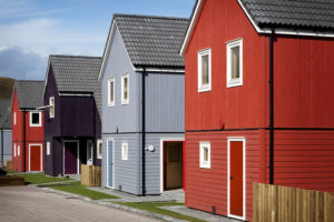 four different coloured timber Scandinavian style houses