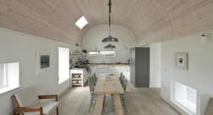 white room with rustic furniture and a arched timber ceiling
