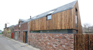 retrofitted mews building with charred timber upper section