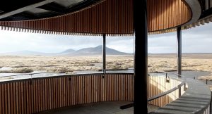 oval shaped timber viewpoint looking over bog land to some mountains