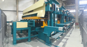 Huge blue machine used for creating Cross Laminated Timber